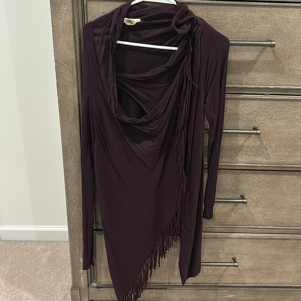 Plum colored sweater. Botton in top left corner by the clavicle.